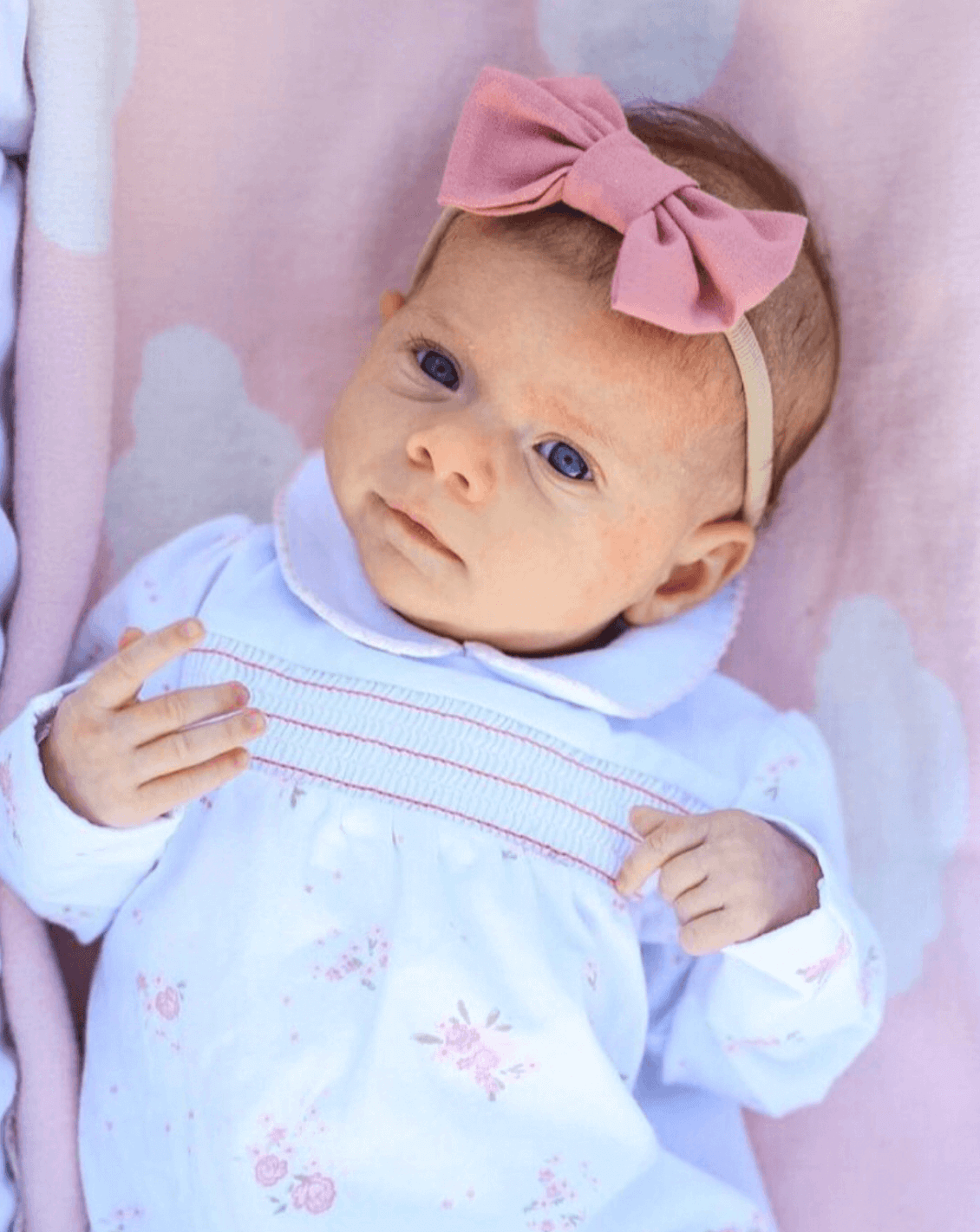 Newborn girl is wearing a pink nylon headband for newborn from By Bella Boutique. Newborn girl is wearing a pink nylon headband for newborn from By Bella Boutique.
