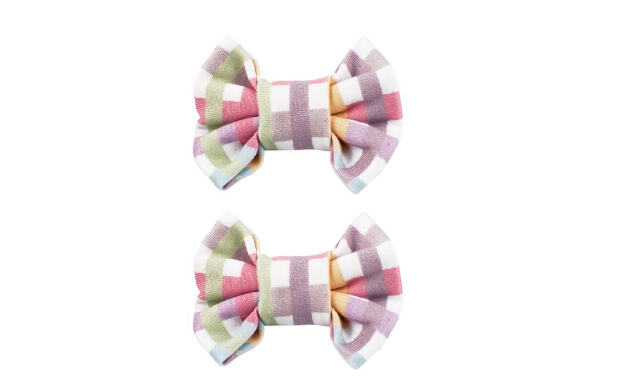 A set of two bow clips featuring a plaid pattern from By Bella Boutique.