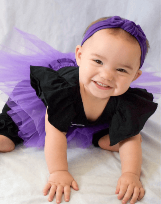 Little girl is wearing a knotted head wrap for girls from By Bella Boutique. Little girl is wearing a knotted head wrap for girls from By Bella Boutique.