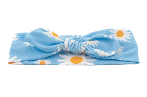 A knot headband featuring a daisy print for baby girls from By Bella Boutique. A knot headband featuring a daisy print for baby girls from By Bella Boutique.