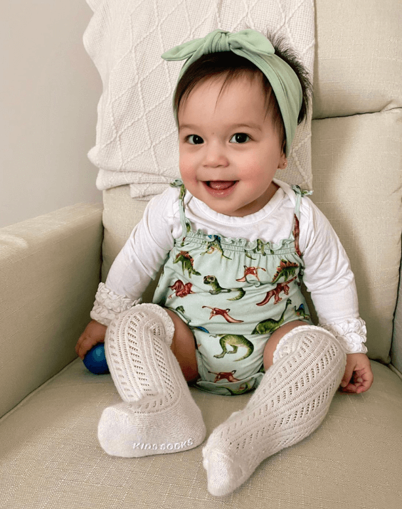 Little girl is wearing a comfortable baby headband for little girls from By Bella Boutique. Little girl is wearing a comfortable baby headband for little girls from By Bella Boutique.