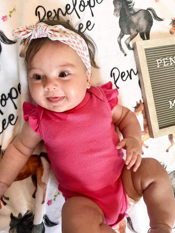 Little girl is wearing a top knot headband for little girls from By Bella Boutique. Little girl is wearing a top knot headband for little girls from By Bella Boutique.