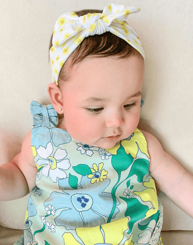 Baby girl is wearing the most comfortable headband featuring a sun pattern from By Bella Boutique. Baby girl is wearing the most comfortable headband featuring a sun pattern from By Bella Boutique.