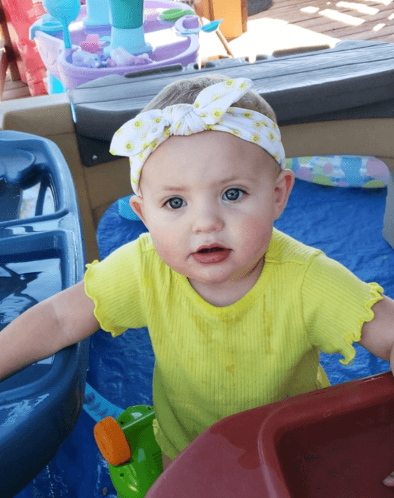 Baby girl is wearing a comfortable baby head wrap from By Bella Boutique. Baby girl is wearing a comfortable baby head wrap from By Bella Boutique.