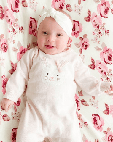 Baby girl is wearing a white baby head wrap for girls from By Bella Boutique. Baby girl is wearing a white baby head wrap for girls from By Bella Boutique.