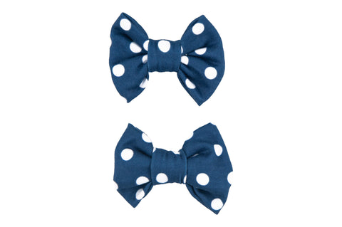 A set of two blue polka dot bow clips for toddler girls from By Bella Boutique. A set of two blue polka dot bow clips for toddler girls from By Bella Boutique.