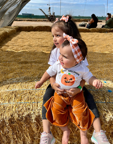 Little girl is wearing a baby head wrap for little girls from By Bella Boutique.