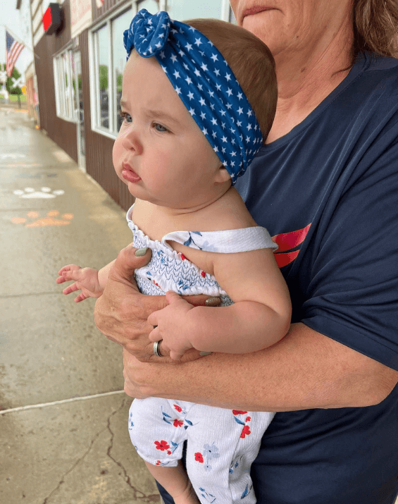 Little girl is wearing a baby girl headband for little girls from By Bella Boutique.