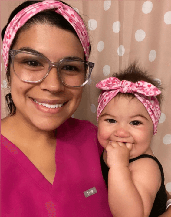 Mom and daughter are wearing matching mommy and me headwraps featuring barbie print from By Bella Boutique.
