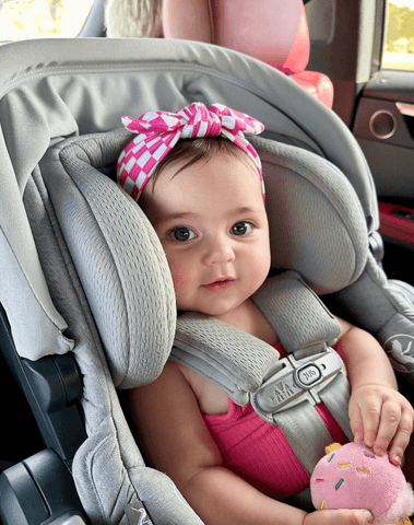 Baby girl is wearing a soft baby headband for little girls from By Bella Boutique.