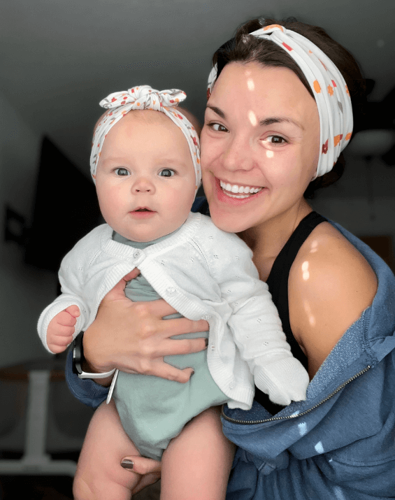 Mom and daughter are wearing matching mommy and me head wraps from By Bella Boutique.