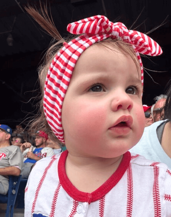 Baby girl is wearing a baby head wrap for little girls from By Bella Boutique. 