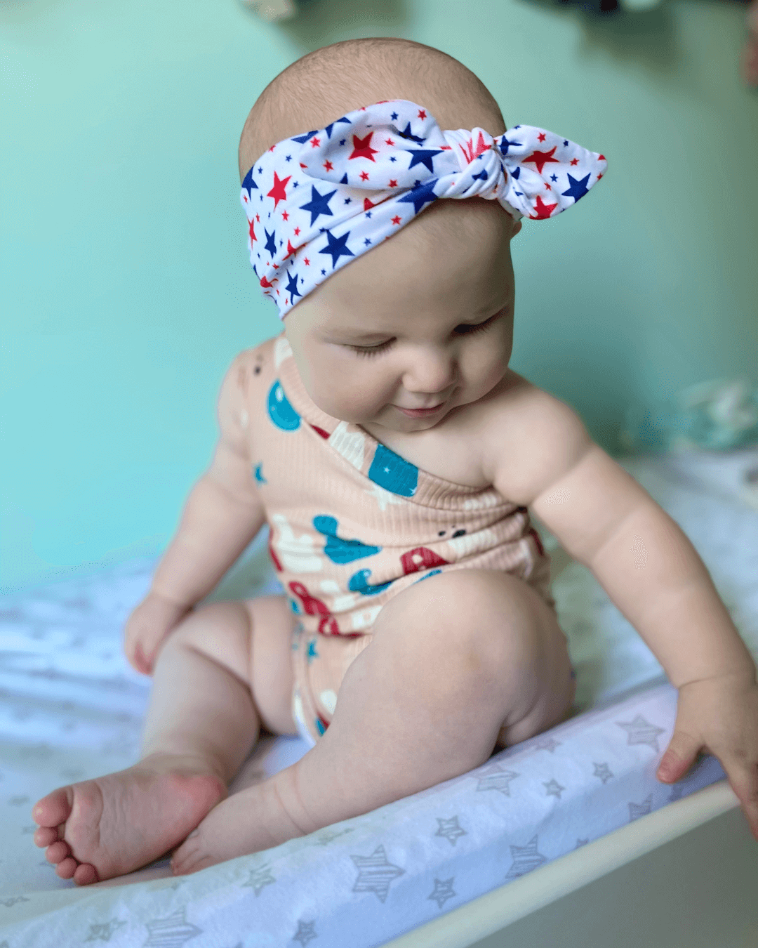 Baby girl is wearing a baby headband for girls from By Bella Boutique.