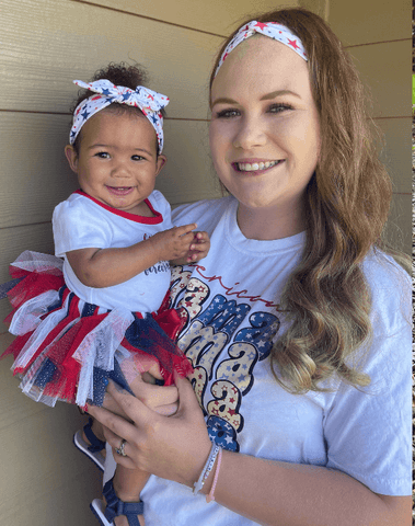 Little girl and mom are wearing matching mommy and me head wraps from By Bella Boutique.