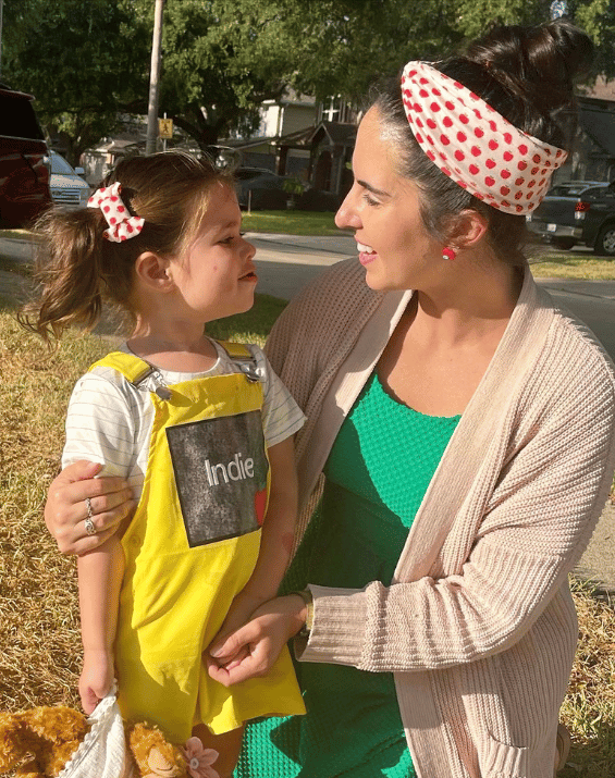 Mom and daughter are wearing matching mommy and me head wraps from By Bella Boutique.