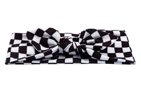 A baby head wrap for little girls featuring a white checkerboard pattern from By Bella Boutique.