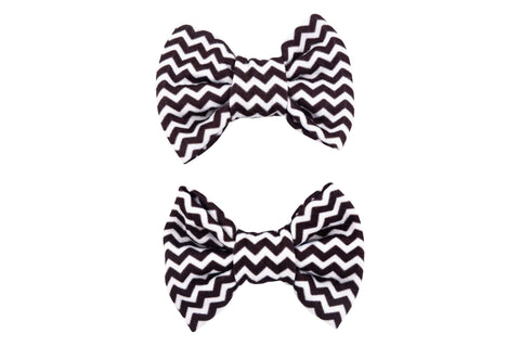 A set of two pigtail bows for toddler girls featuring a black and white chevron print from By Bella Boutique.