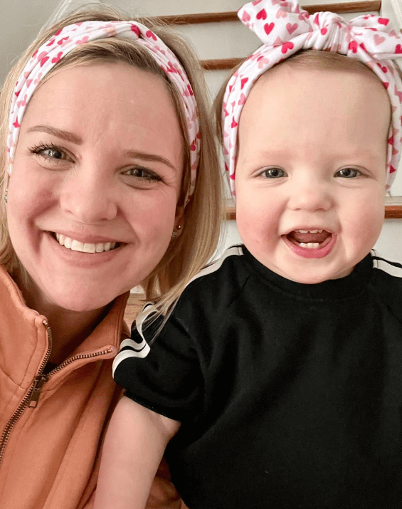 Mom and baby girl are wearing matching mommy and me headbands from By Bella Boutique.