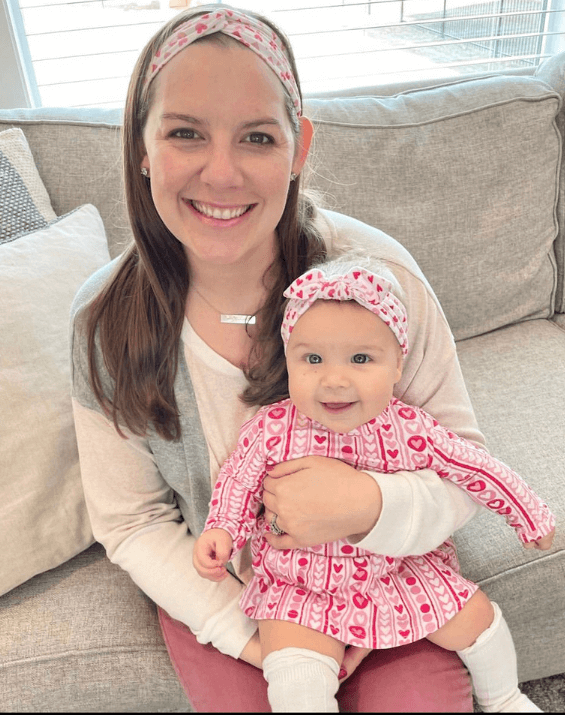 Mom and daughter are wearing matching mommy and me headwraps from By Bella Boutique.