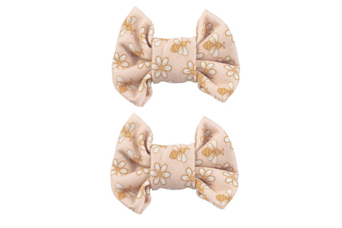 A set of two handmade bow clips featuring a boho print for little girls from By Bella Boutique.