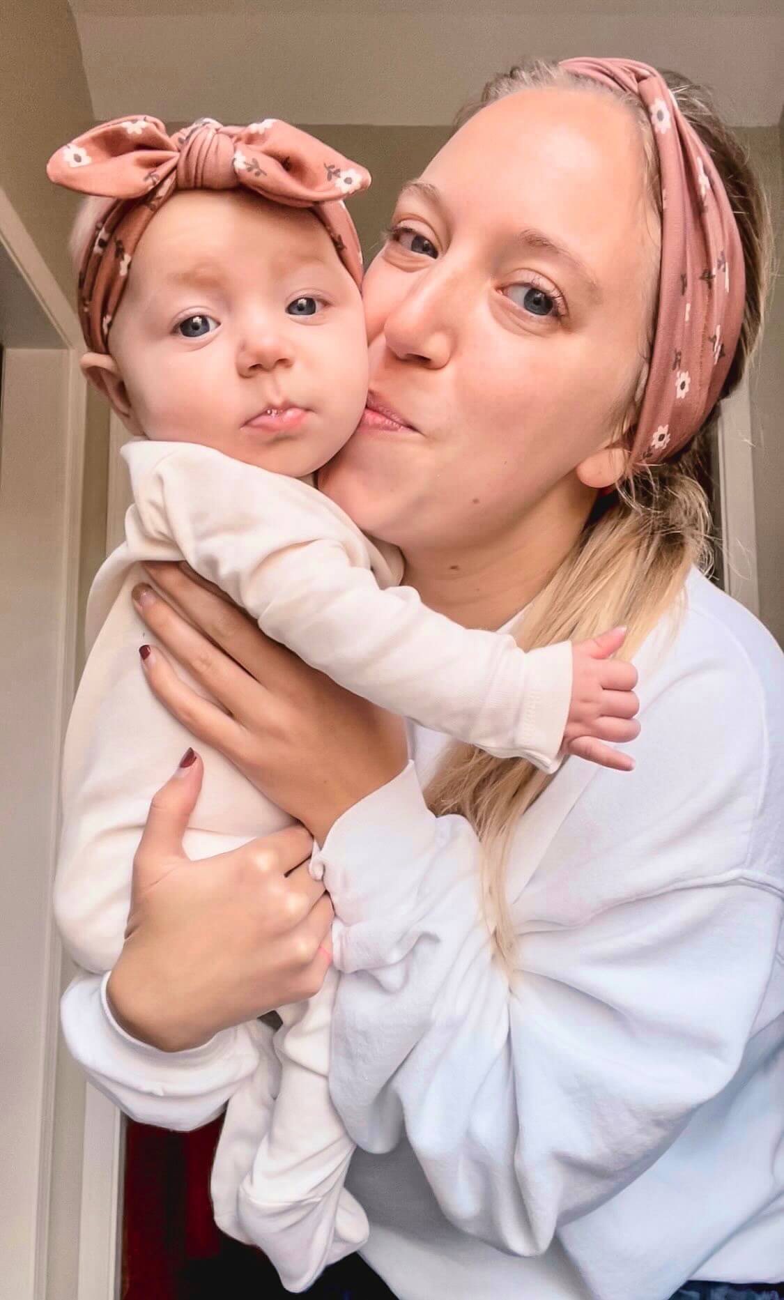 Mom is wearing matching mommy and me headwraps from By Bella Boutique.