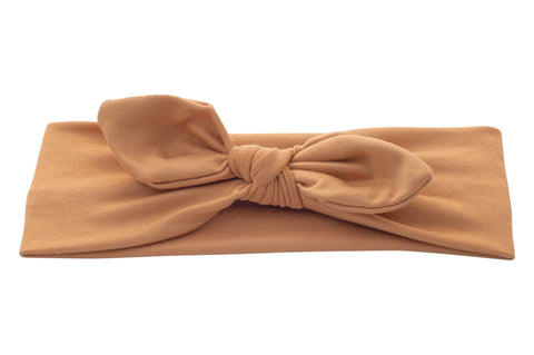 A handmade neutral knotted headband for little girls from By Bella Boutique.