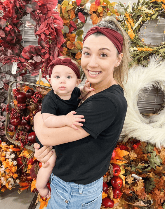 Mom and baby girl are wearing matching and me headbands from By Bella Boutique.
