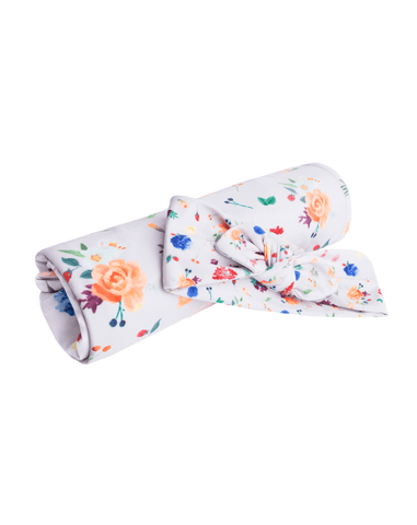 Swaddle and bow set featuring a floral pattern for newborn girls from By Bella Boutique.