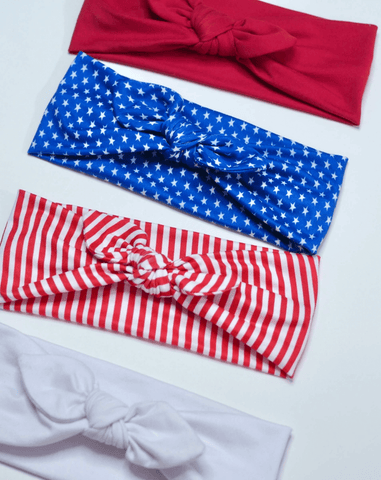 A collection of fourth of july knotted headbands for little girls from By Bella Boutique.