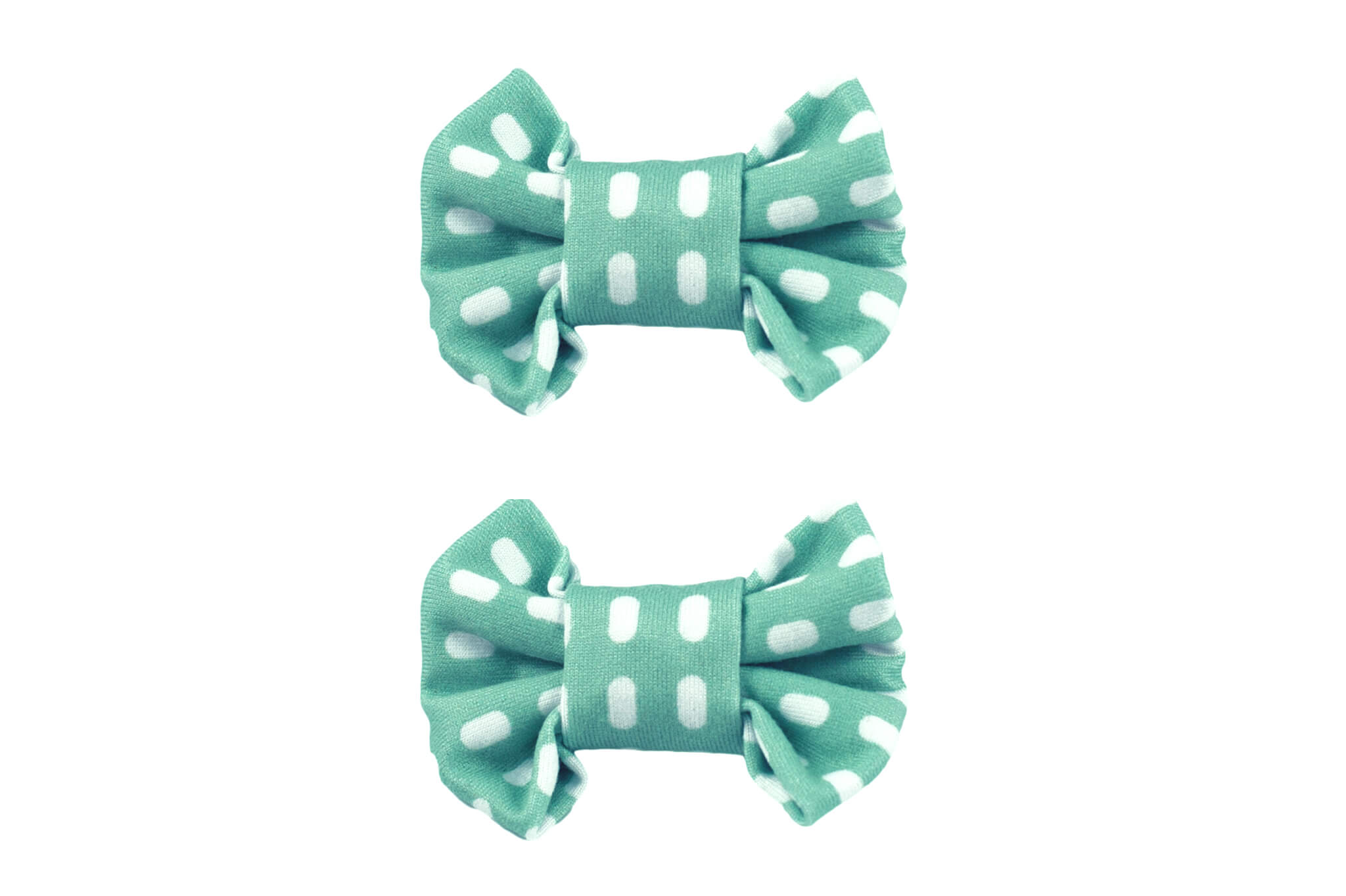 A pair of bow clips featuring a white and green pattern for toddler girls from By Bella Boutique.