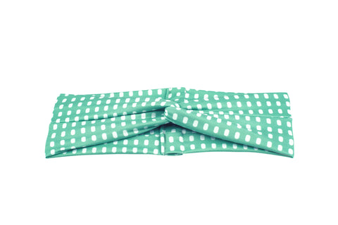 A handmade turban headband featuring a dot pattern for women from By Bella Boutique. 