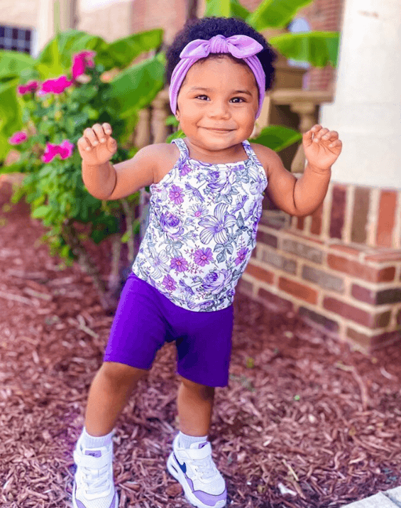 Baby girl is wearing the most comfortable headband for little girls from By Bella Boutique.