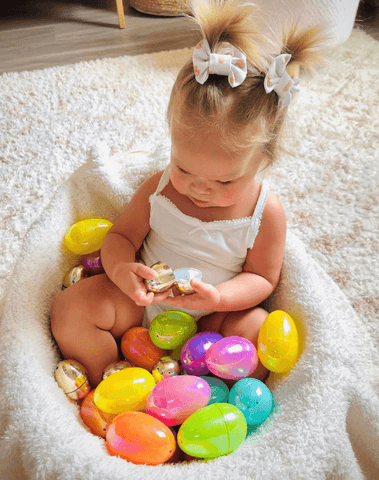 Toddler girl is wearing a set of clip bows for toddler girls from By Bella Boutique.