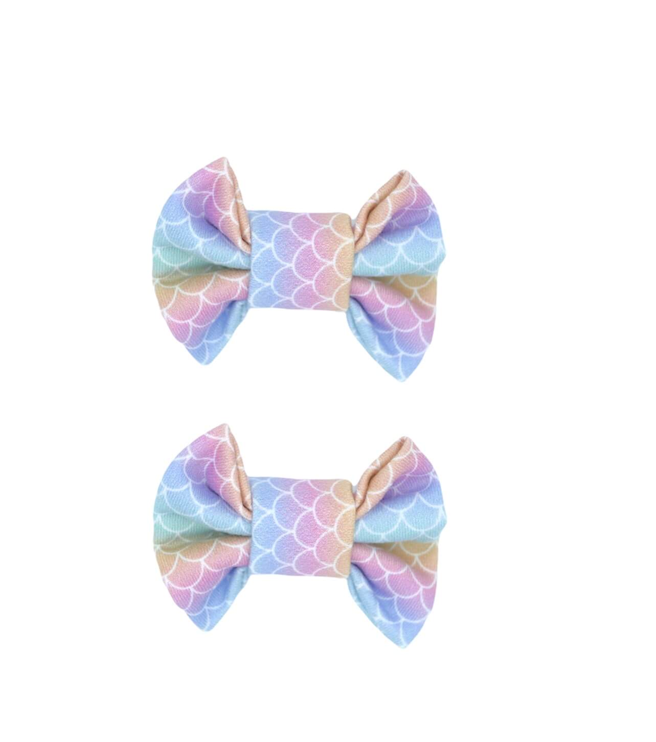 A set of two mermaid print bow clips for toddler girls from By Bella Boutique.