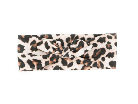 A top knot headband featuring a leopard print for little girls from By Bella Boutique.