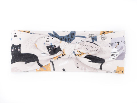 A comfortable handmade headband for babies featuring a cat print from By Bella Boutique.