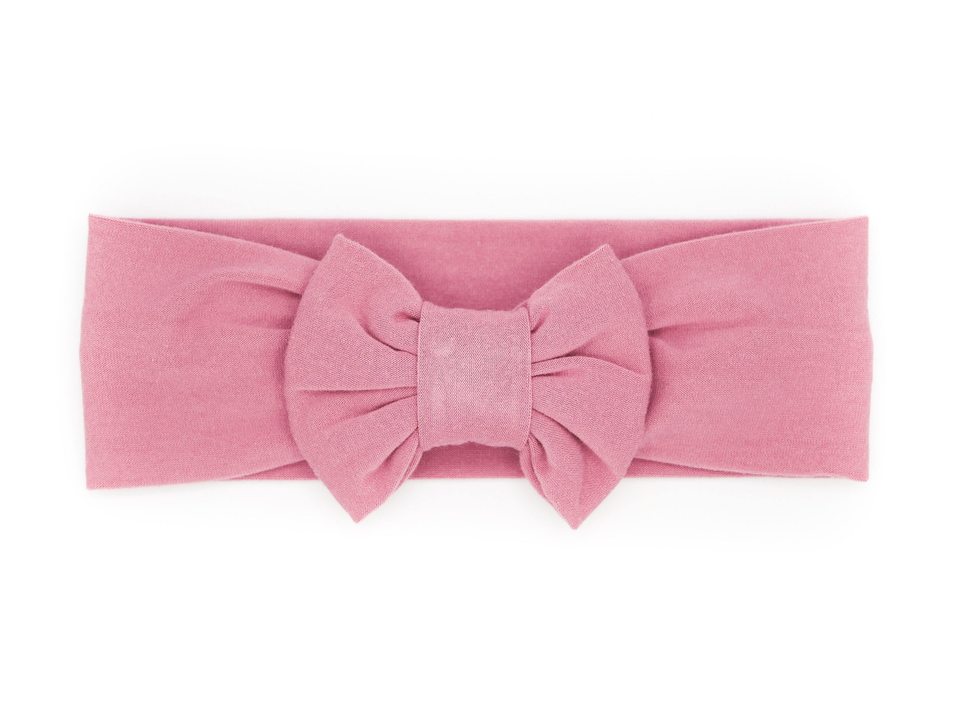 A handmade pink bow headband for little girls from By Bella Boutique.