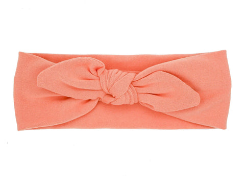 Orange knotted headband for baby girls from By Bella Boutique.