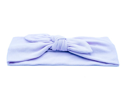 A lilac knotted head wrap from By Bella Boutique.