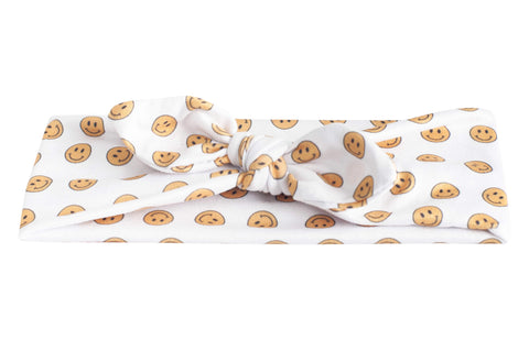 A comfortable baby headband featuring a smiley pattern. 