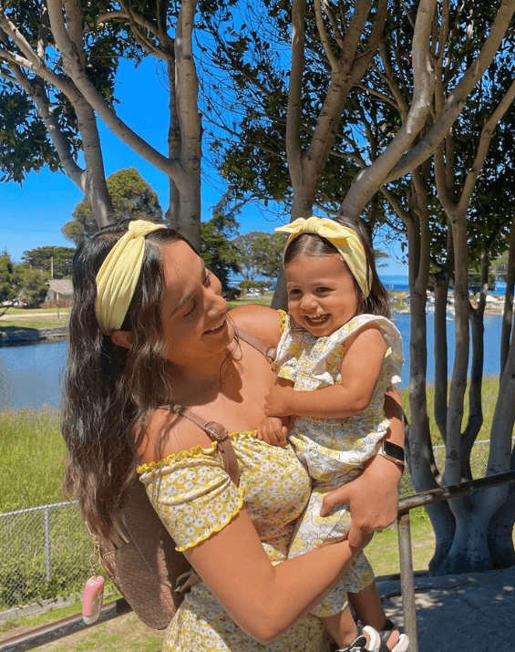 Mom and baby girl are wearing matching mommy and me headbands from By Bella Boutique.