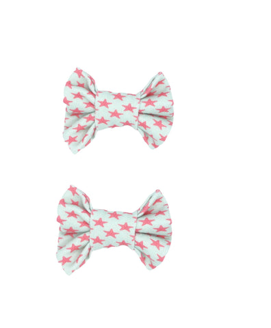 A set of two starfish print bow clips for toddler girls from By Bella Boutique.