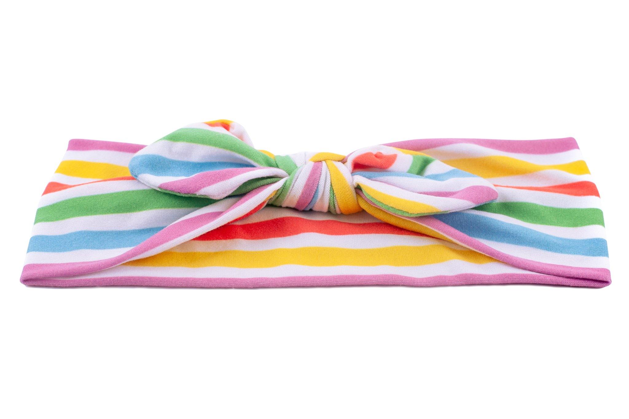 A handmade top knot headband featuring a rainbow pattern from By Bella Boutique.