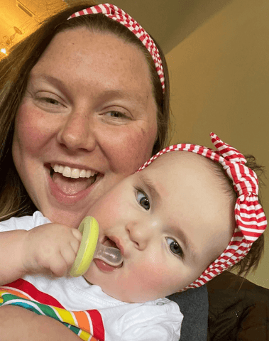 Mom and baby girl are wearing matching mommy and me headbands from By Bella Boutique.