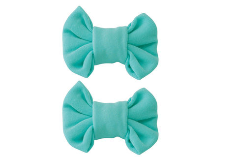 A pair of handmade clip bows for toddler girls from By Bella Boutique.