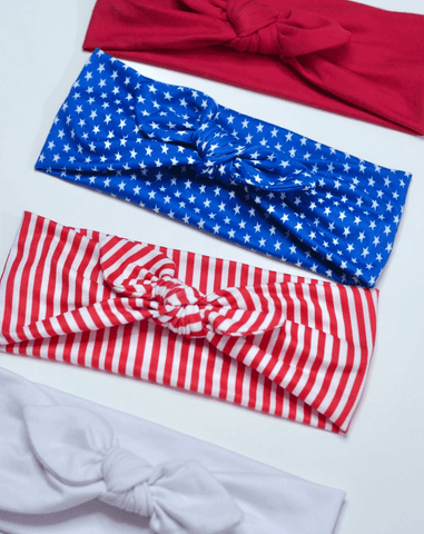 A set of knotted head wraps for little girls featuring a fourth of july pattern from By Bella Boutique.