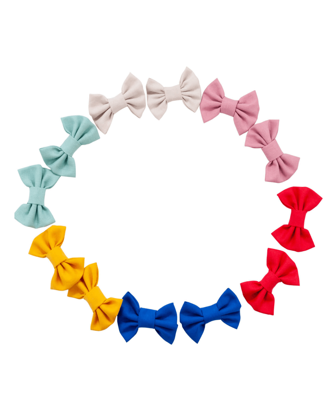 A set of handmade piggy bow tie hair clips for toddler girls from By Bella Boutique.