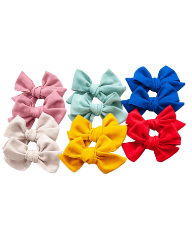 A set of linen pinwheel bows for toddler girls from By Bella Boutique.