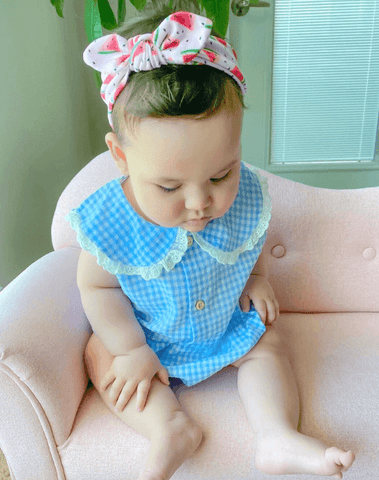 Baby girl is wearing a comfortable baby girl bow for little girls from By Bella Boutique.