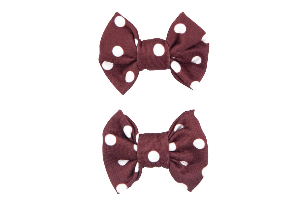 A set of brown polka dot bow clips for toddler girls from By Bella Boutique.